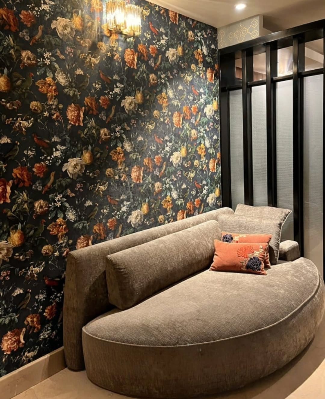 A WALL BEHIND A SOFA WITH FABRIC NATION JAMMU WALLPAPERS USED