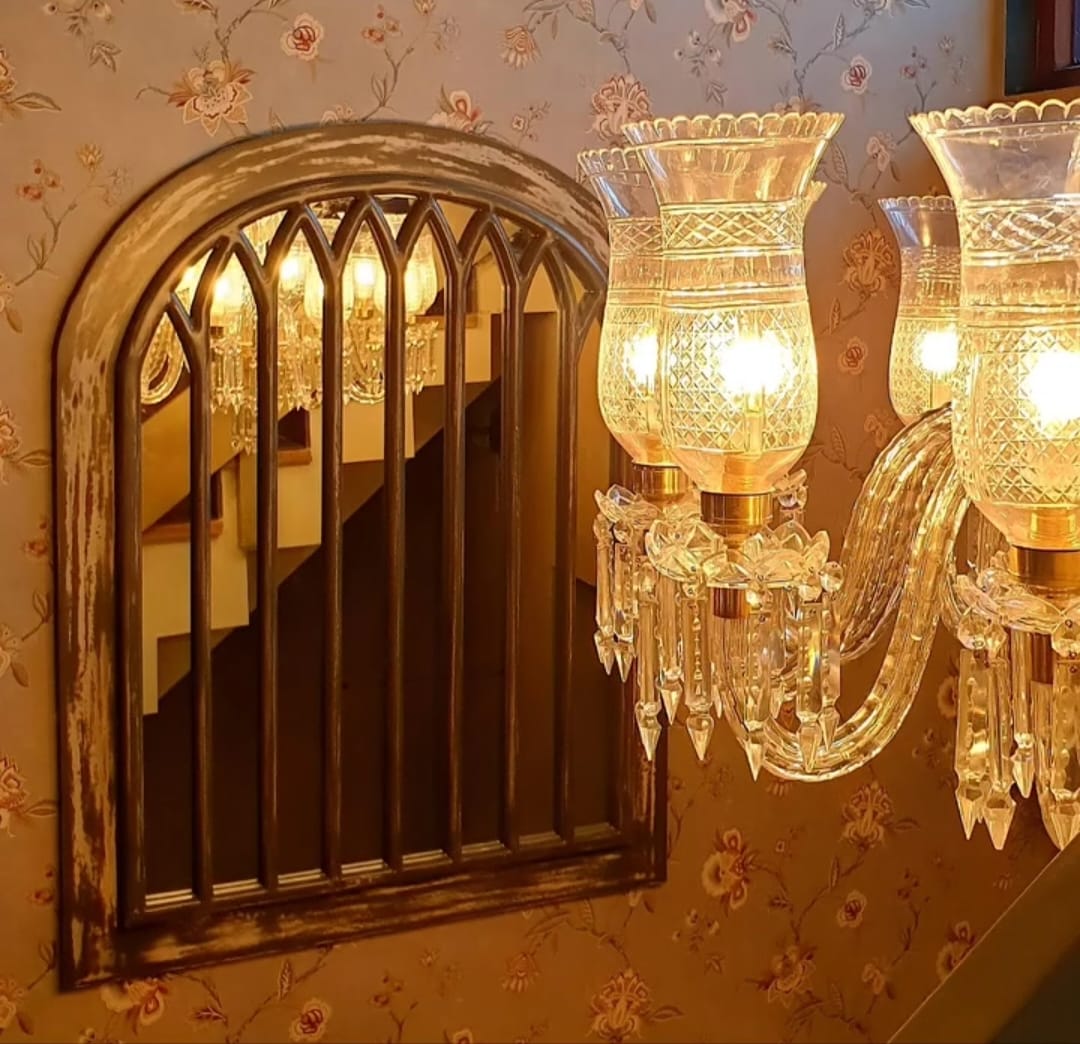 A WALL BEHIND A SOFA WITH FABRIC NATION JAMMU WALLPAPERS USED